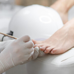 Professional In Beauty Salon Cleaning Nails On Feet